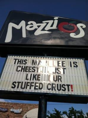 It says "This marquee is cheesy, just like our stuffed crust!"