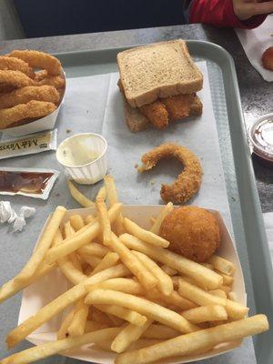 Onion rings to top left, and fries and hush puppy for first mate meal.