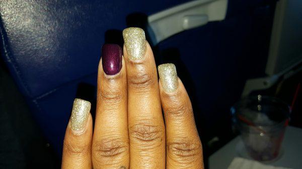 Wide slanted acrylic set with gel polish. The older lady with the glasses did.