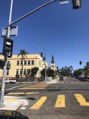 Down the street, the spire is visible