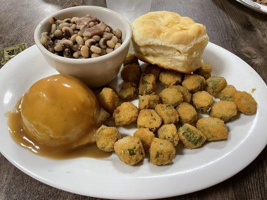 Veggie plate with mashed potatoes & gravy, fried okra and purple hull peas. Delicious fluffy biscuit!