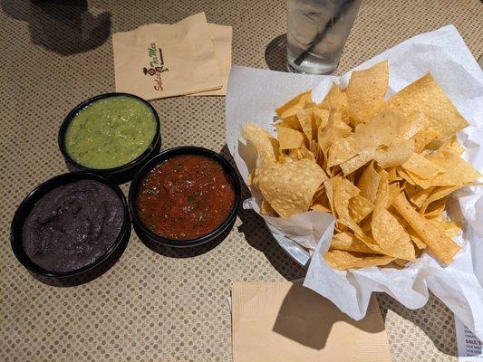 Paper thin, hot chips with red salsa, green salsa and black bean dip!