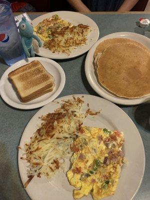 Pancakes and western omelette. Cool even split the meal for us and gave us each a large helping of hash browns.