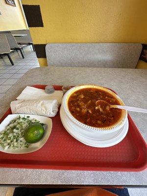 Menudo, onion cilantro lime, seasoning on the side with corn tortillas.