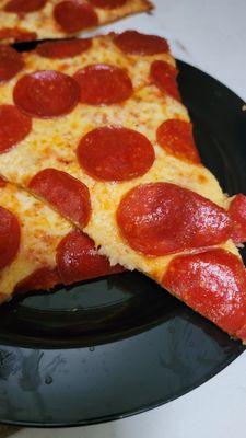 Pepperoni and garlic pie cut pizza. Delicious.