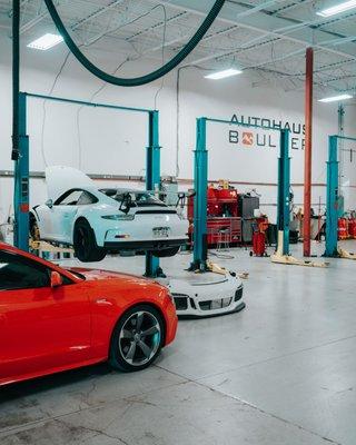 Audi and Porsche inside the shop.