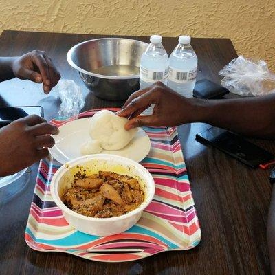 Customers eating lunch @ Toni's. Egusi & Poundo yam.