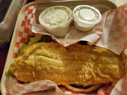 Fried fish sandwich, large and lightly battered. Good taste.