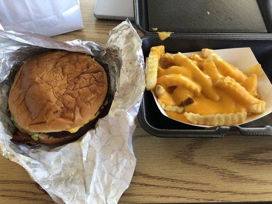 Cold jumbo bacon cheese burger with dried cheese fries.