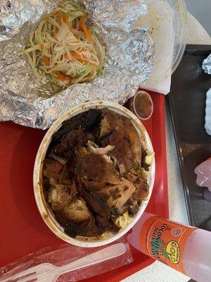 Medium jerk chicken meal with side of cole slaw and 100% cocount juice