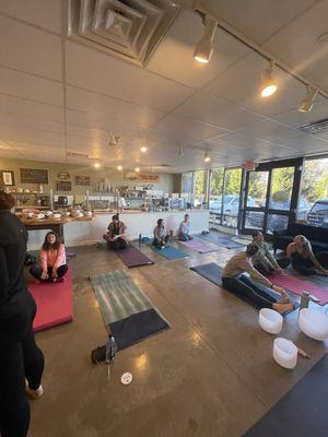 Tables were moved for the yoga practice. Space feels warm and cozy but there is quite a lot of seating.