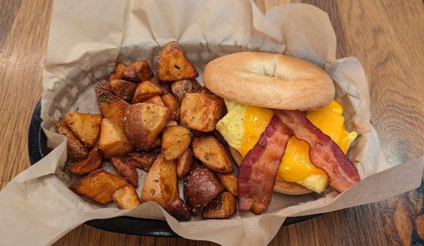 Scrambled egg, bacon and cheese on a griddle toasted bagel. YUM