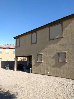 5 Beige custom sun screens on a two-story home