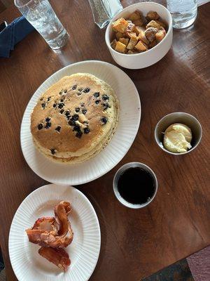 Blueberry pancakes, bacon, potatoes