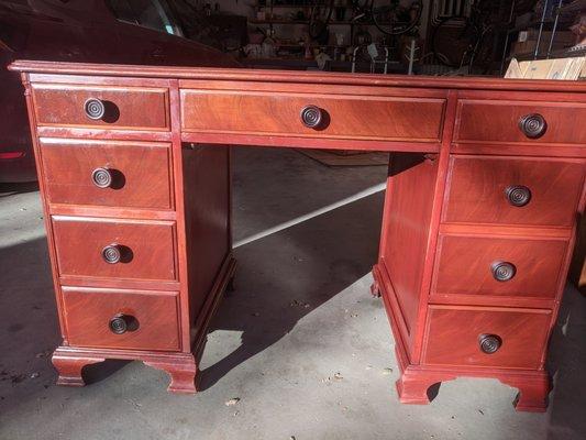 1940s to 50's office desk. mahogany color.  from Maddox Colonial Reproductions, Jamestown NY . 8 drawers, one a filedrawer. L 48" W 24" H 30