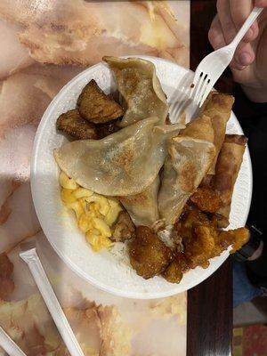 Dinner buffet: dumplings, potatoes, mac n cheese, Egg Roll, and rice.