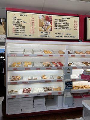 Inside: peering behind the counter at the donuts waiting to go home with me today