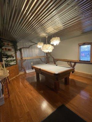 Fun pool table with an adorable bar area