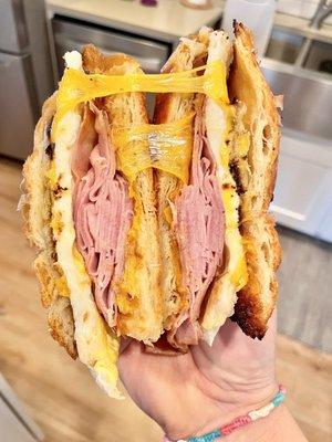 Ham, egg and cheddar on a croissant