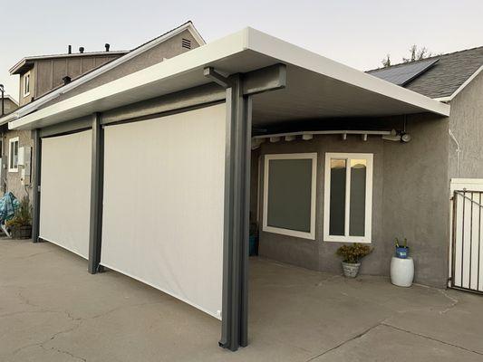 26x12 insulated patio cover with electrical fan, outlets, and crank roller shades.