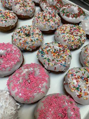 Assorted white cake donuts.