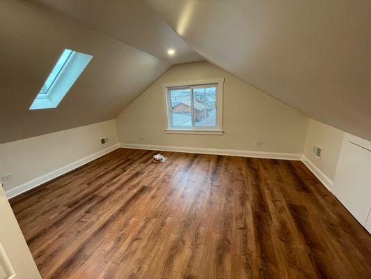 After. Remodeled bedroom with skylight and storage closet in the knee walls. No more carpet.