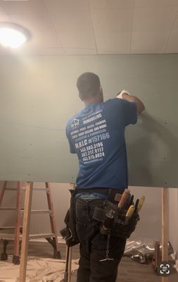 Hanging drywall.