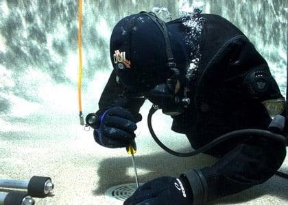 One of our experienced leak detection dry suit divers at work.