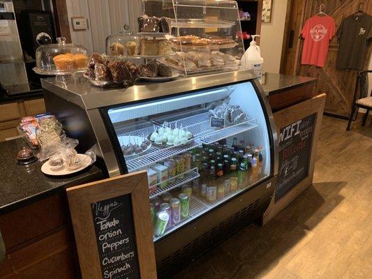 Larger view of baked goods on cooler by the order counter with wifi password (did not work for me) and various merchandise available