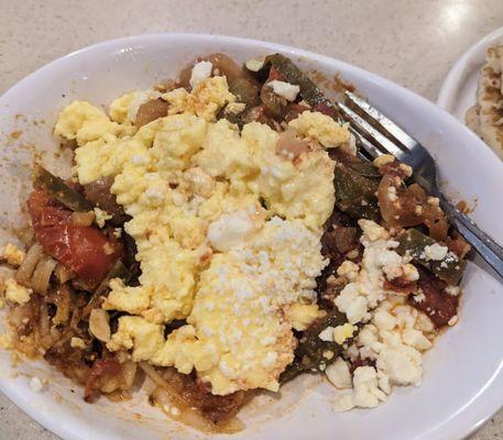 Delicious Shakshouka skillet (layers of feta cheese, hash browns, chili-cumin spiced sauce, eggs) and it comes with toast or pancakes!! Yum