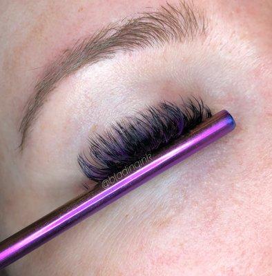 Shorter volume lashes with purple lashes mixed in by Marie Mitchell