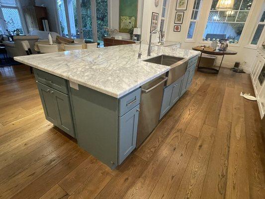 New kitchen island with under lights and jumbo marble slab.