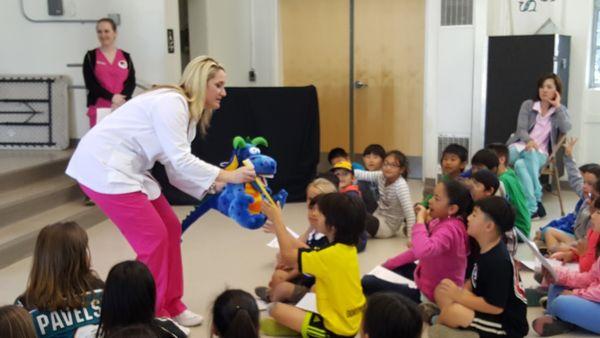 Blanco Family Dental Volunteering to teach children at one of our local schools the importance of proper oral hygiene.