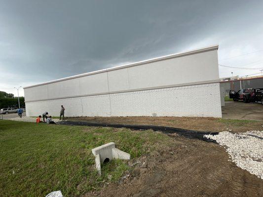 Commercial project in Dallas.  A 150 foot drainage swell was installed to prevent water running under the structure.