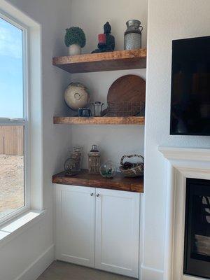 Custom cabinets and shelving next to fireplace