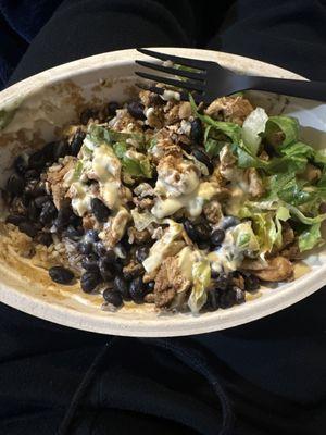 Chicken bowl with brown rice, black beans, light lettuce, a very small scoop of queso.