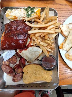 Trio platter with ribs, sausage, brisket quesadillas, fries, corn and Texas toast