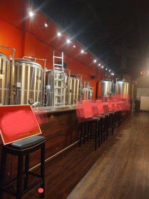 Side beer room with bar, tvs and tables.