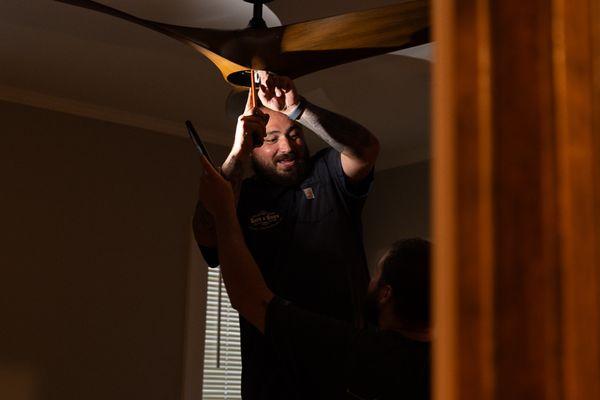 Darrell with assistance from Dylan, installing one of our new ceiling fans. They're awesome