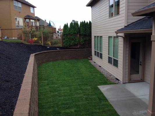 Finished back yard,  the yard used to be hill right up to the house.