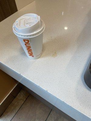 Coffee leaking as it was slammed down on the counter by staff.