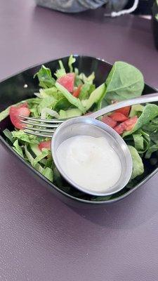 Ranch side salad with tomato and cucumber.