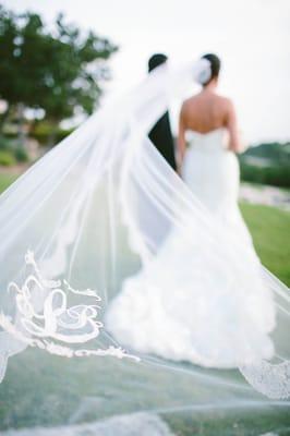 One of our beautiful brides in her veil with her groom.