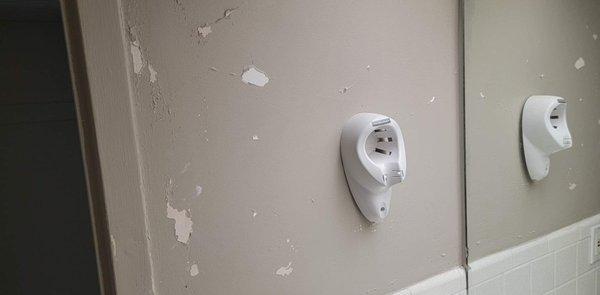 Peeling paint in the bathroom and missing hair dryer.