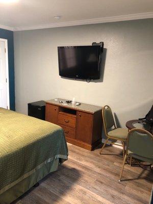 Mini fridge, tv, and table with chairs