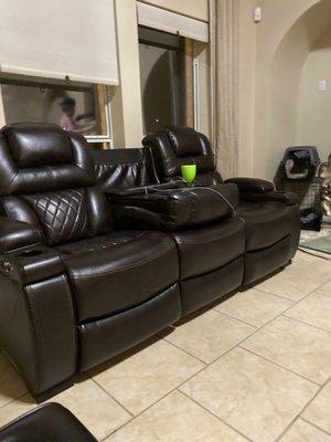 Our new leather Ashley couch showing center feature if you want extra cup holders and electronic outlets! Bonus!