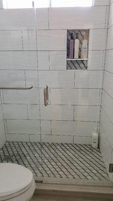 New bathroom tile with niche and glass doors