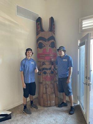 Three guys and a totem (one is missing from the photo)