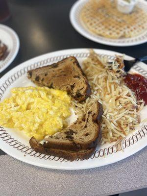 Eggs with cheese, raisin toast, hashbrowns