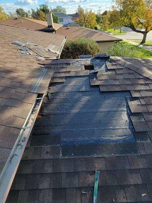 Tear off partial shingles below vent to trace leak.